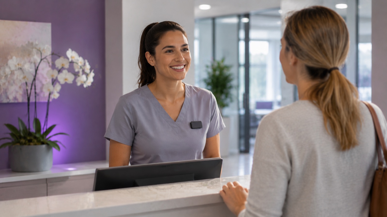 receptionist helping a customer at a front desk